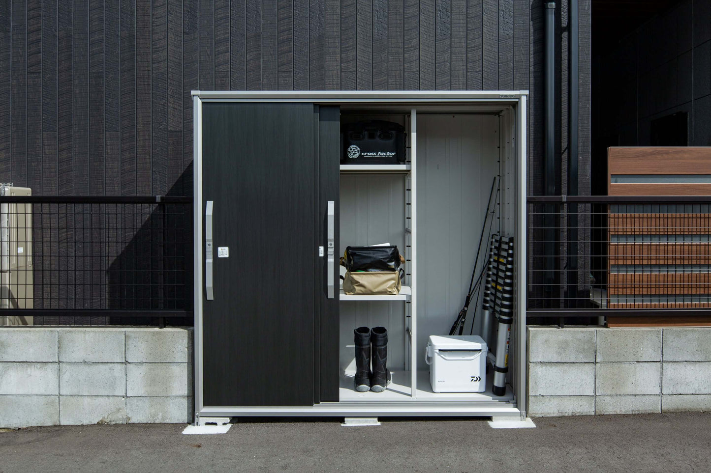 YODOKO Premium Outdoor Small Shed ESF with smooth sliding door and organized interior for storage, showcasing Japanese craftsmanship.